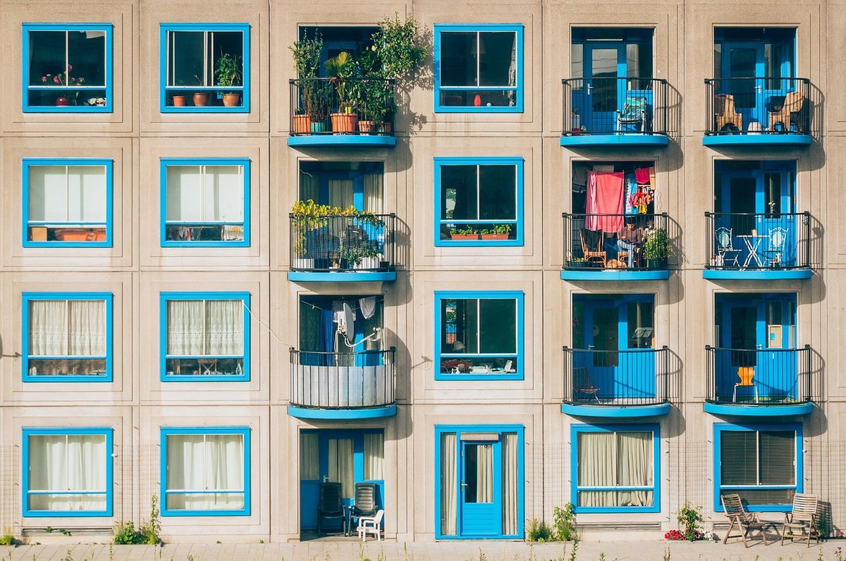 Exterior view of mid-rise apartment balconies and windows