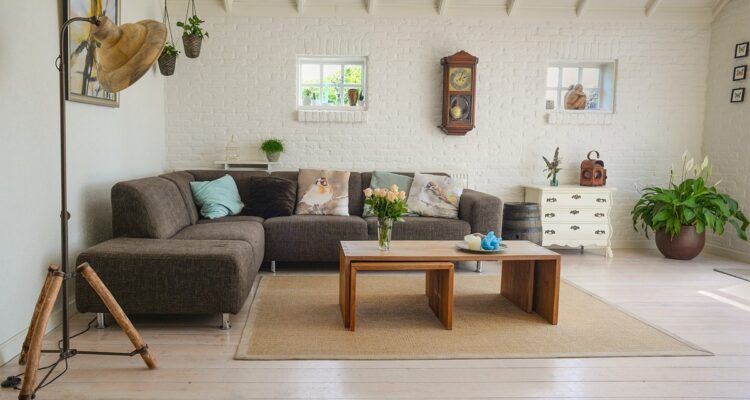 Modern apartment living room with sofa, coffee table and large windows
