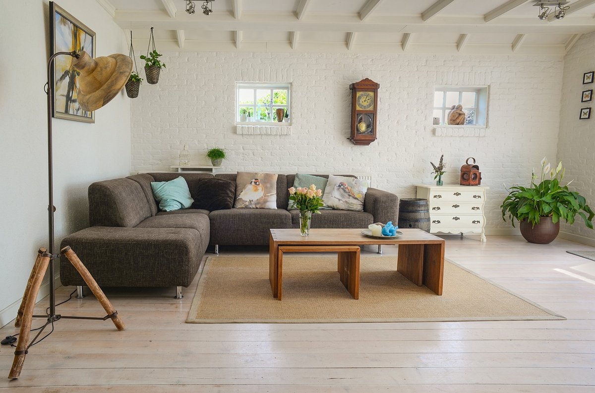 Modern apartment living room with sofa, coffee table and large windows